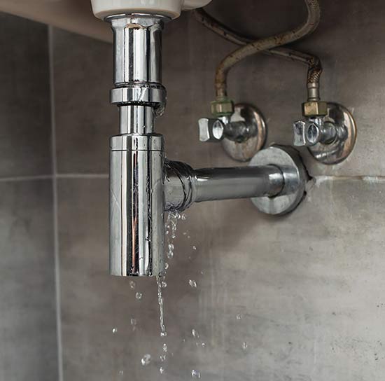 Leaking pipe under a bathroom sink
