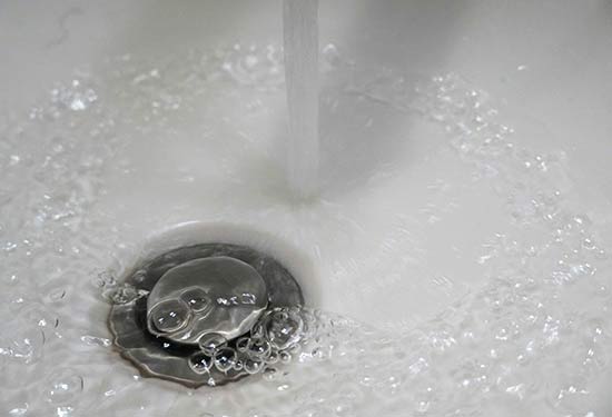 water flowing into a sink drain