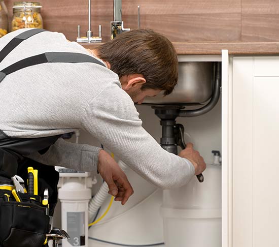 Plumber working on a kitchen sink