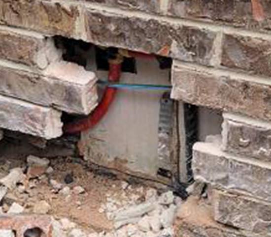 Plumbing pipe leak found by removing part of exterior wall on house