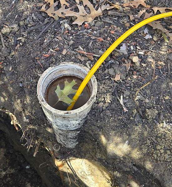 Clogged plumbing pipe being flushed out