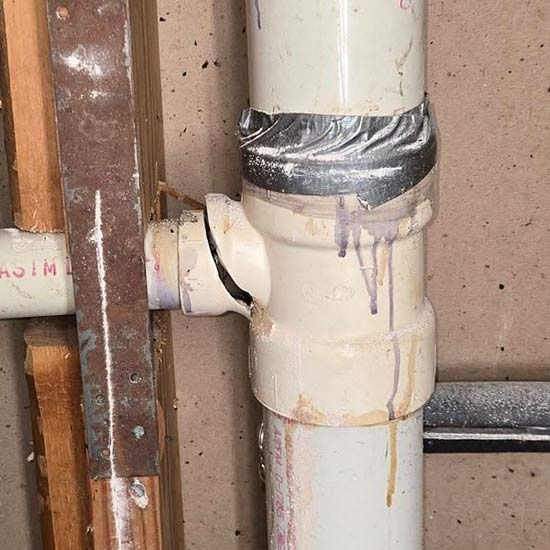 Broken plumbing pipe behind drywall