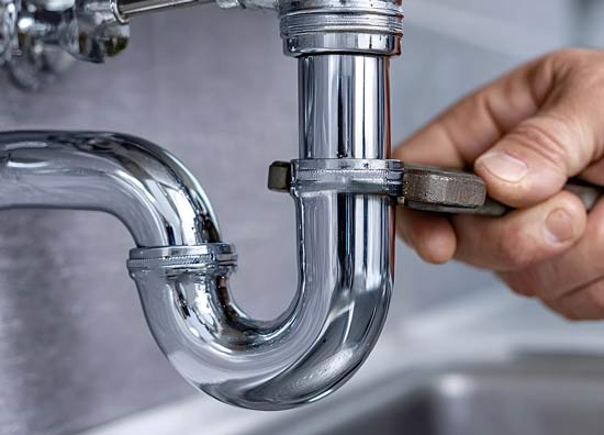 wrench tightening a plumbing pipe