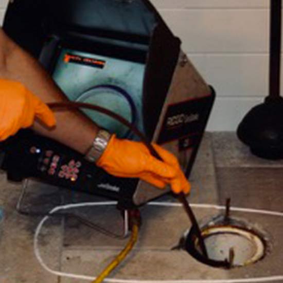 Plumber performing hydrostatic testing to find a leak