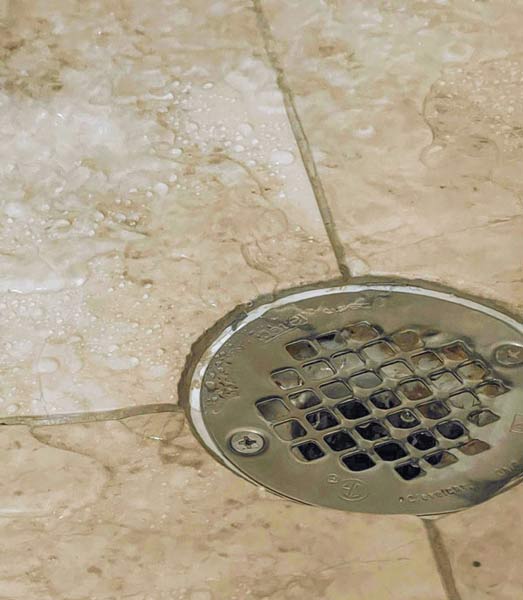 Wet tile next to shower drain