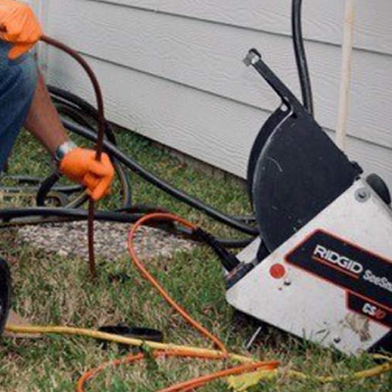 Professional completing camera inspection of plumbing pipes